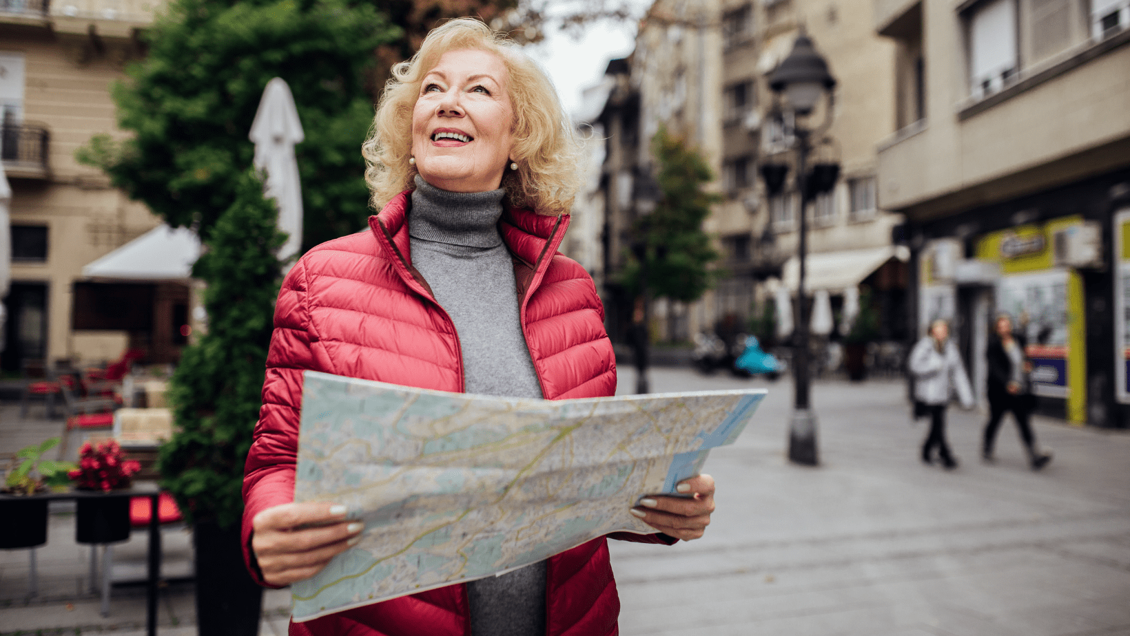 An old female solo traveller wandering the streets with a map in hand