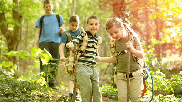 children having fun hiking with their dad