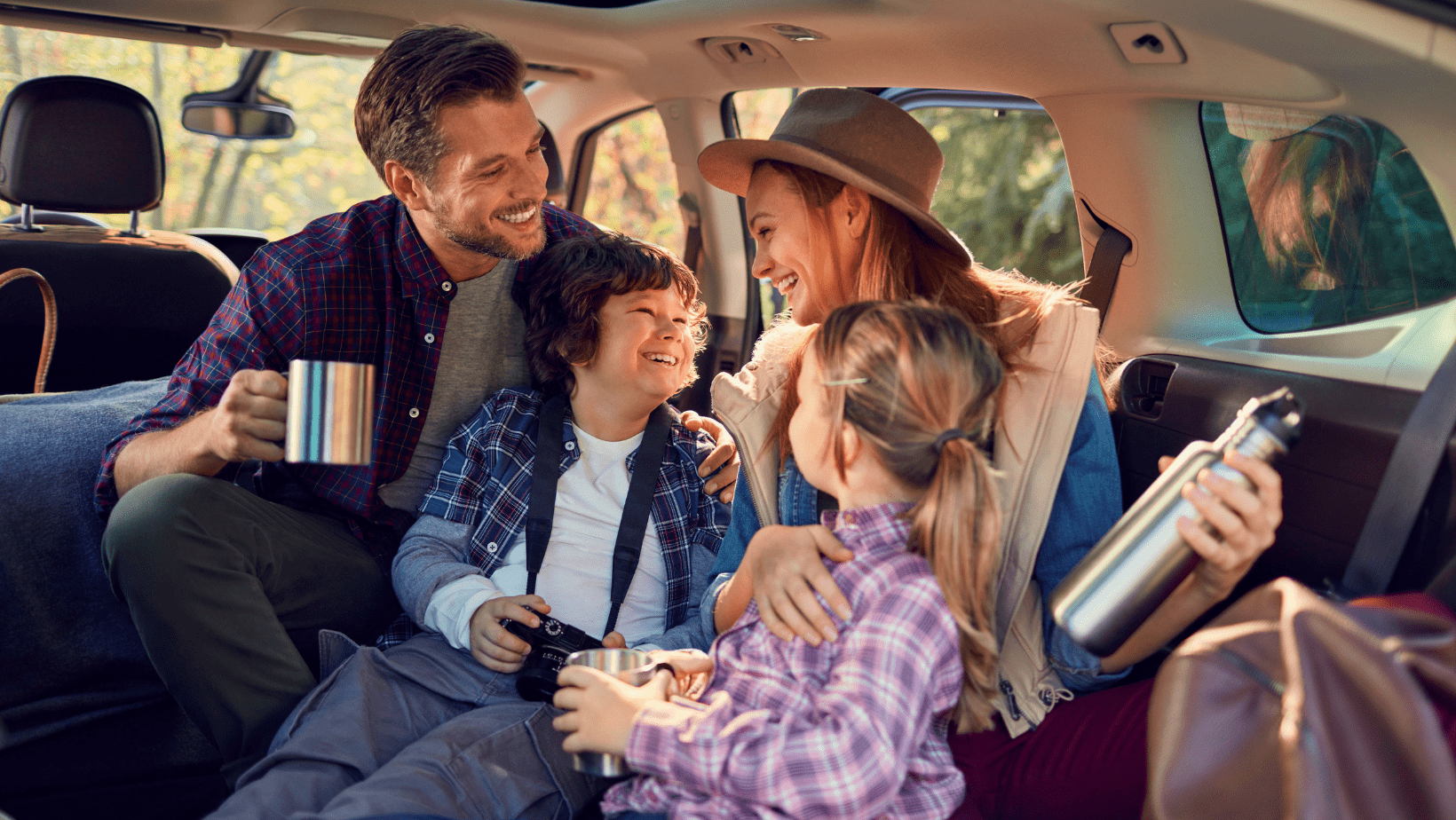 family having fun and laughing while on a road trip
