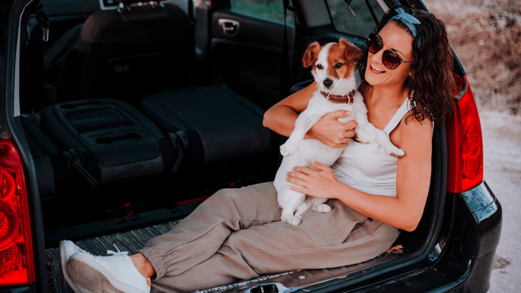 woman with her dog in a car-min
